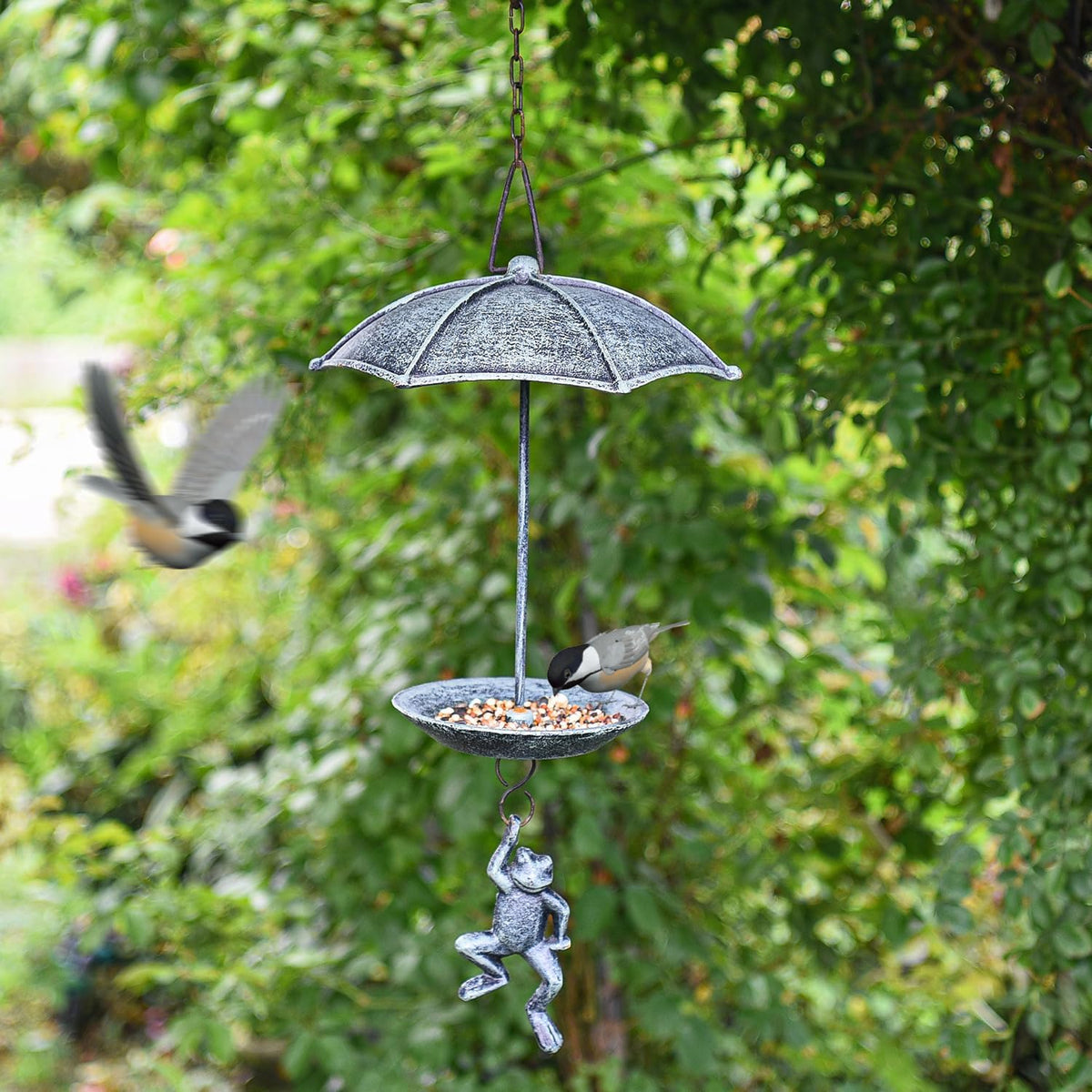 sungmor cast iron hanging bird feeder, vintage green shown in use