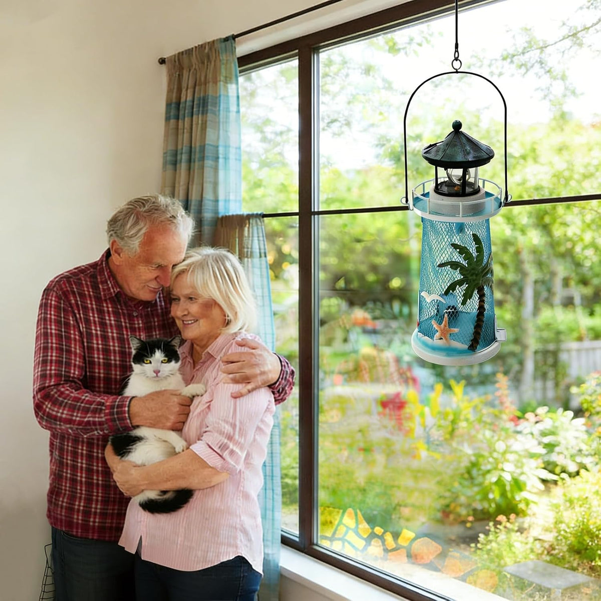 solar lighthouse bird feeder with rotating beacon shown in use