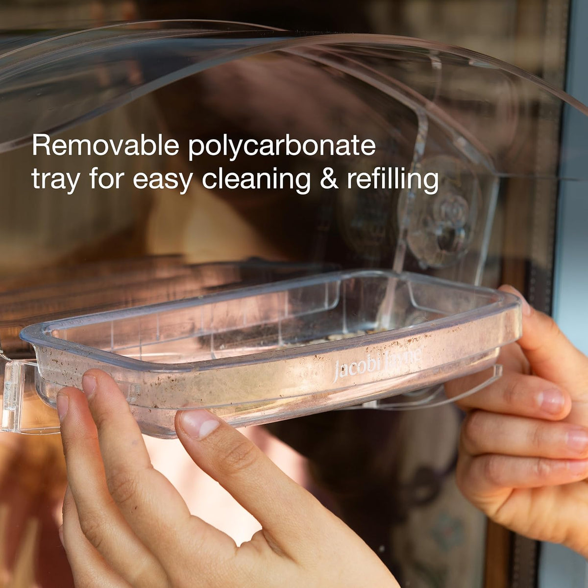 transparent acrylic bird house with sliding tray, side view