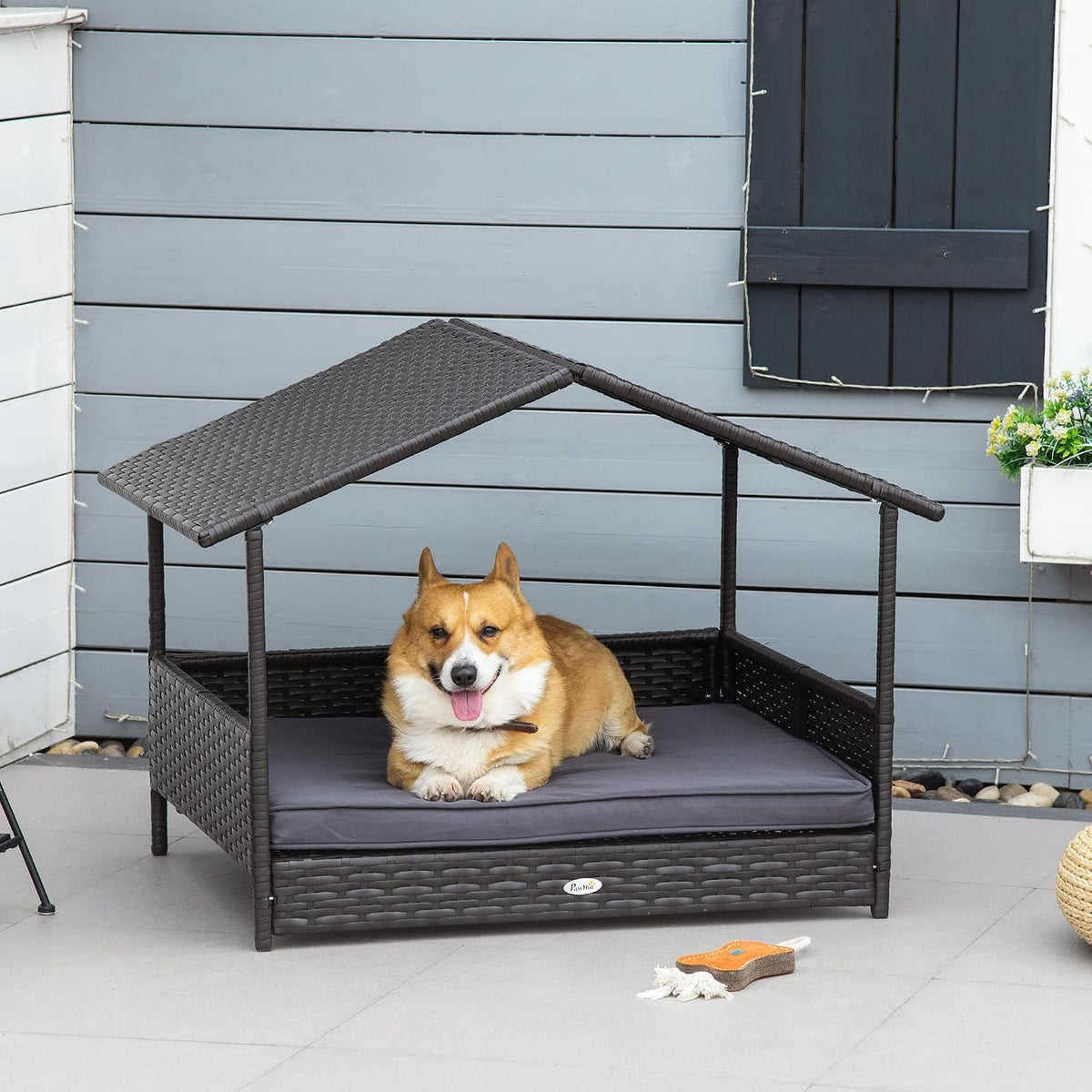 pawhut wicker dog house outdoor with canopy, rattan shown in use